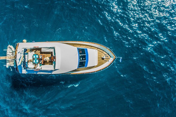 Santorini: Motor Yacht Sunset Cruise with 5-Course Dinner - Volcano cruising without hiking: what you’re doing instead
