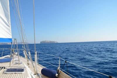Santorini: Private Sailing Yacht Cruise with Meal and Drinks - Lighthouse views and the Santorini volcano/sulfur-springs waters stop